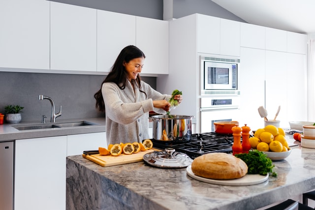 A woman cooking a healthy meal.