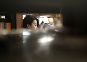 Woman reading in a library, illustrating lesser-known books on women’s rights in Asia during WWII and historical narratives beyond Comfort Women