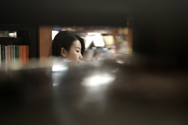 Woman reading in a library, illustrating lesser-known books on women’s rights in Asia during WWII and historical narratives beyond Comfort Women